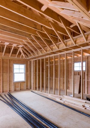 Fragment view beams stick built of new home under construction wood framing beam framework