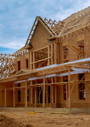 New construction of beam construction house framed the ground up framing against a blue sky